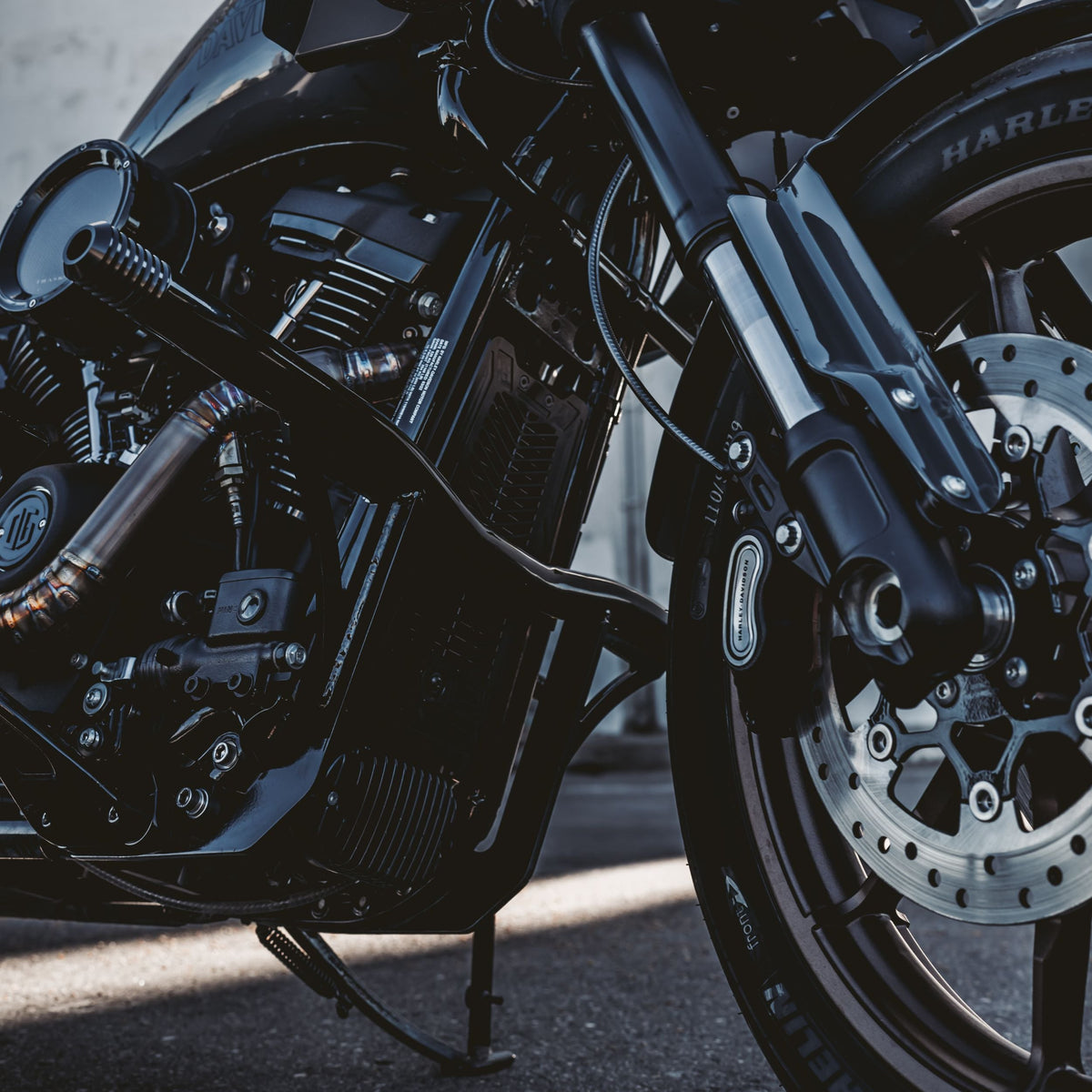 OG Black Highway Peg Crash Bar for Harley-Davidson M8 Softail with Mid Controls installed on a Harley-Davidson FXLRST Low Rider ST 2023
