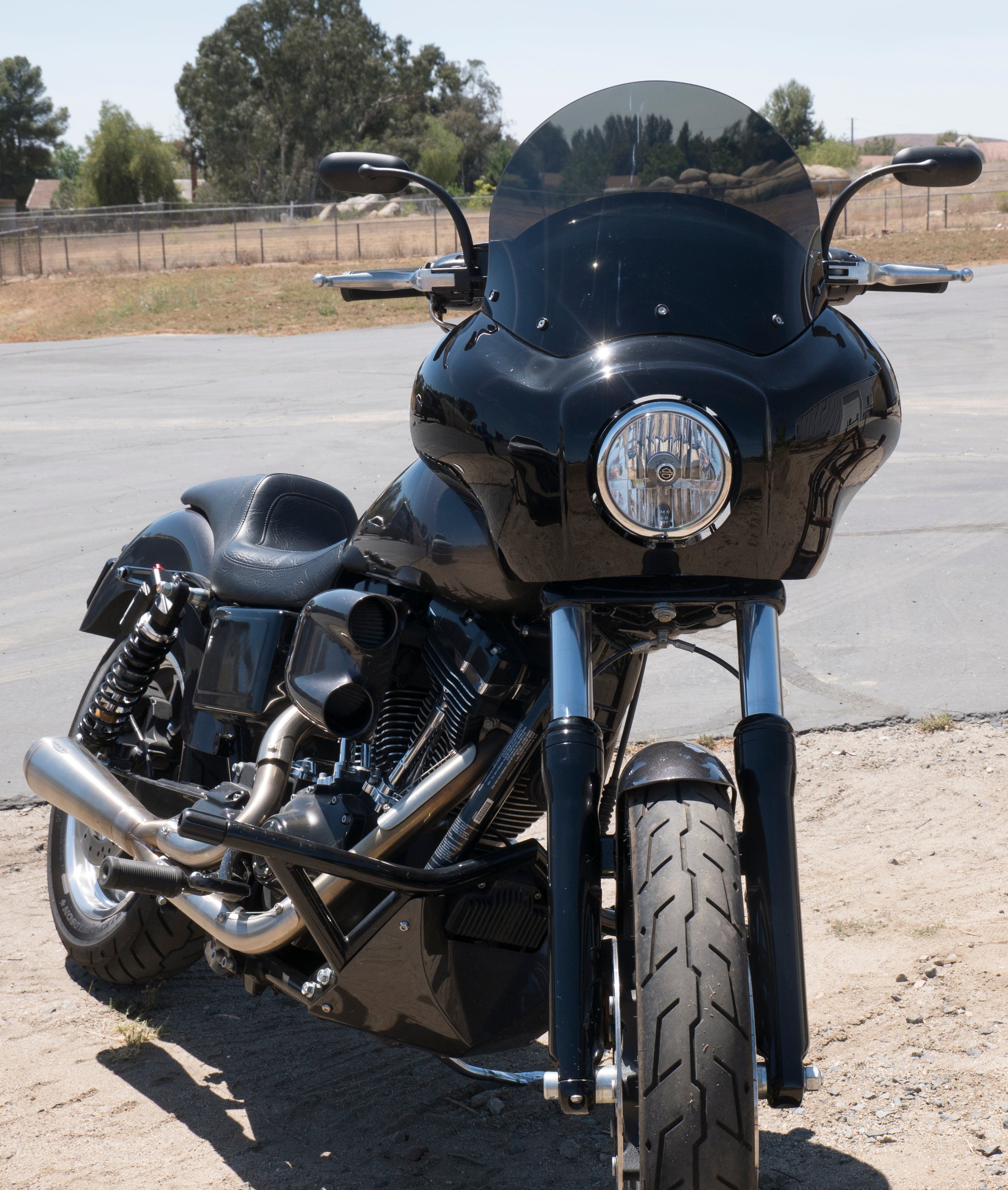 RWD TXR Fairing for Harley Davidson Dyna installed on a motorcycle parked on a road.